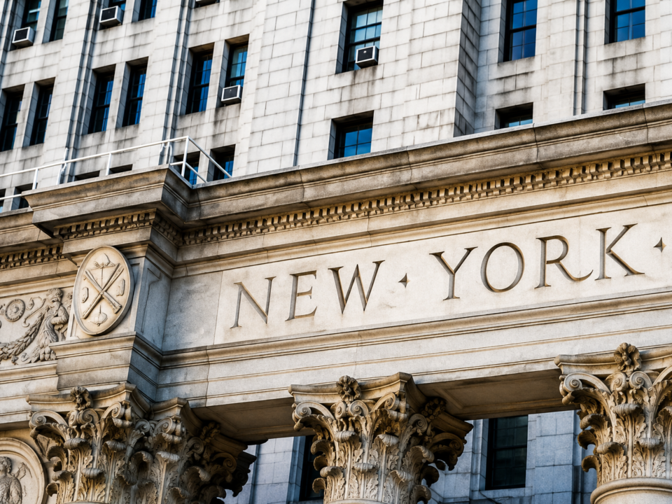 Close-Up Image of a Building With Columns And The Words “NEW YORK” Engraved Across The Façade